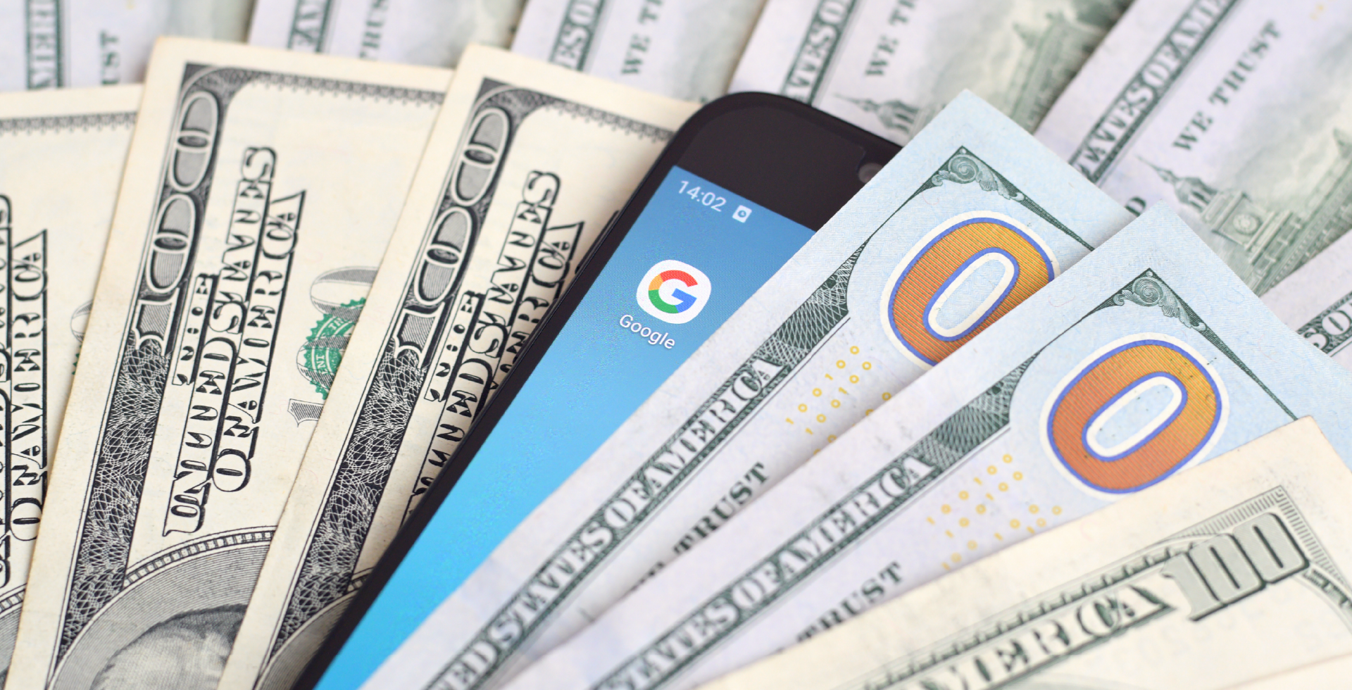 there are a lot of cash moneys and also a phone with google ads app on the screen